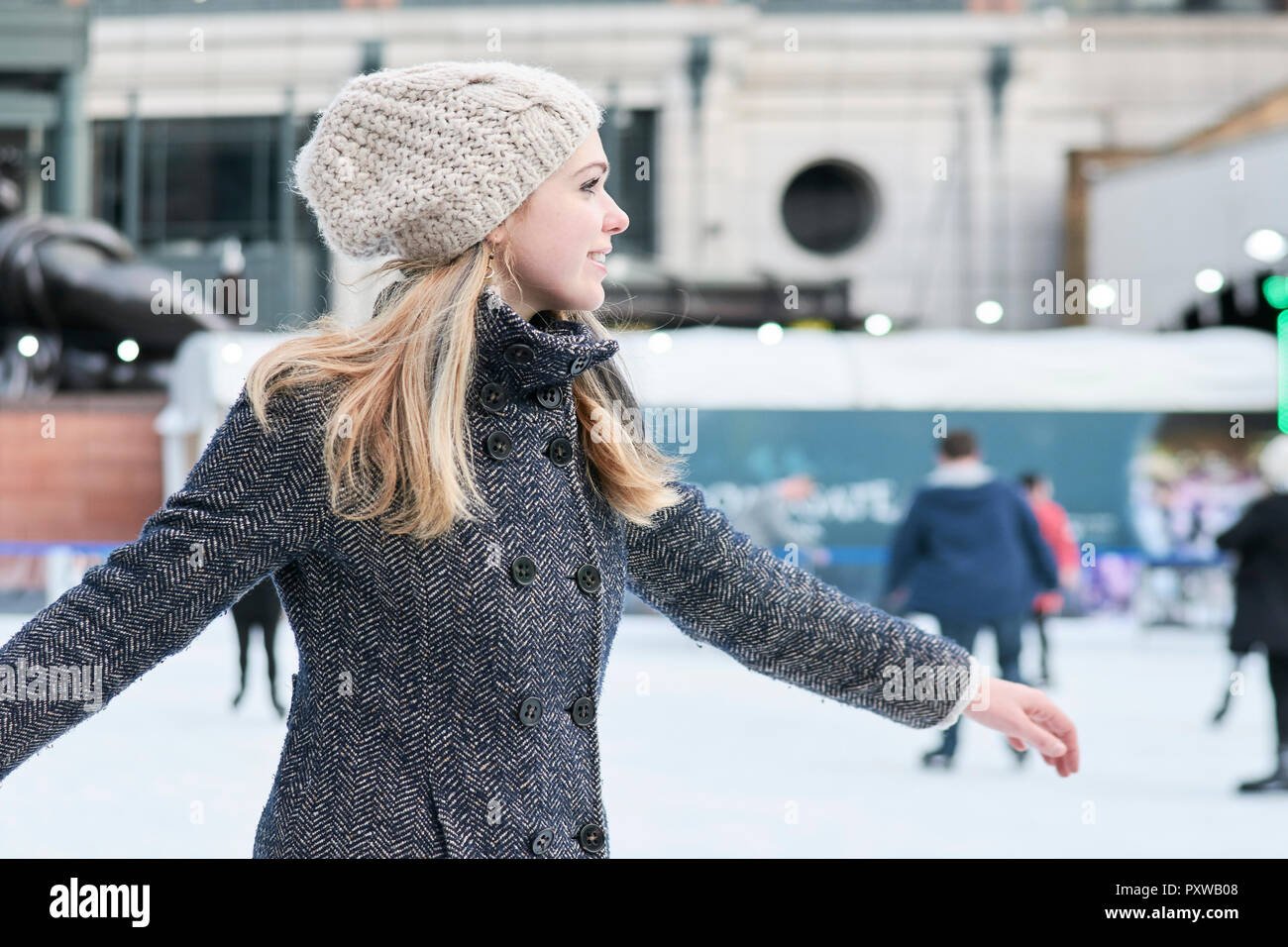 Giovane donna bionda pattinaggio sul ghiaccio Foto Stock