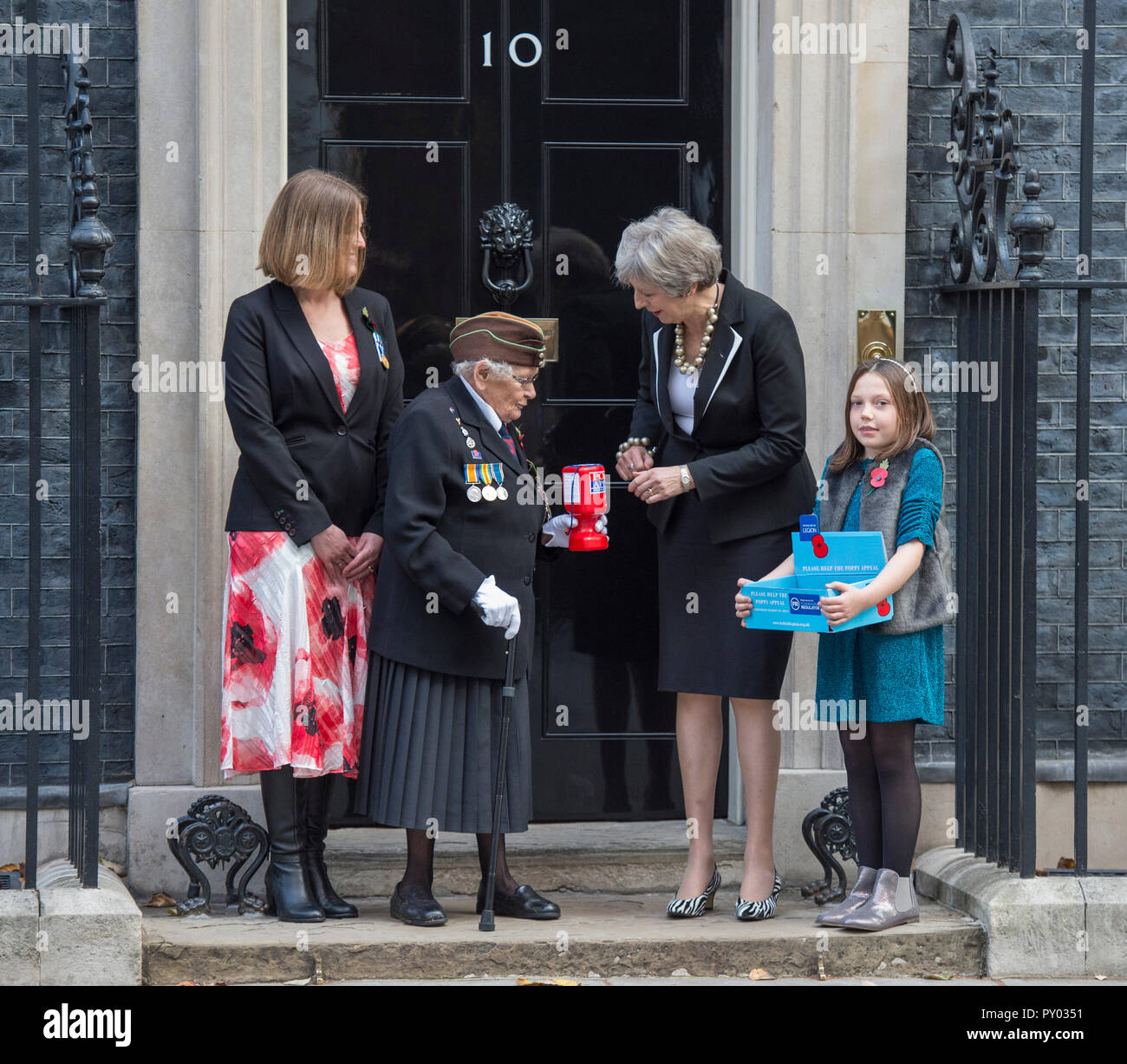 10 Downing Street, Londra, Regno Unito. 25 ottobre, 2018. Il Primo Ministro incontra Beneficienza per il Royal British Legion e acquisti un papavero nella parte anteriore del Downing Street porta. Credito: Malcolm Park/Alamy Live News. Foto Stock