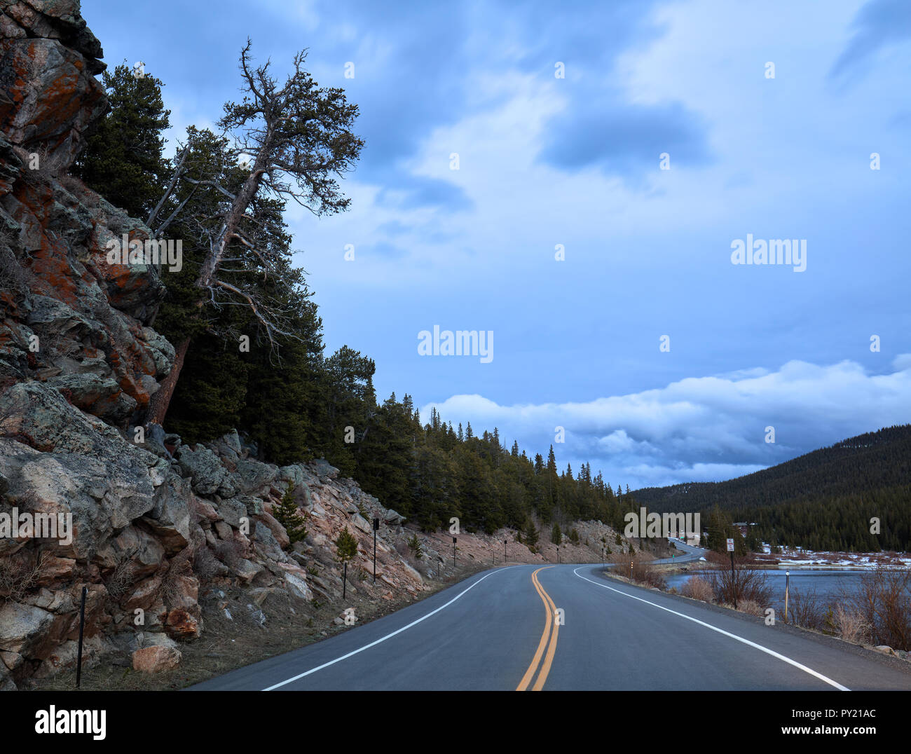 Sera Squaw Pass Road con una inclinazione albero accanto al lago di Echo sul modo di Mount Evans in Colorado, STATI UNITI D'AMERICA Foto Stock