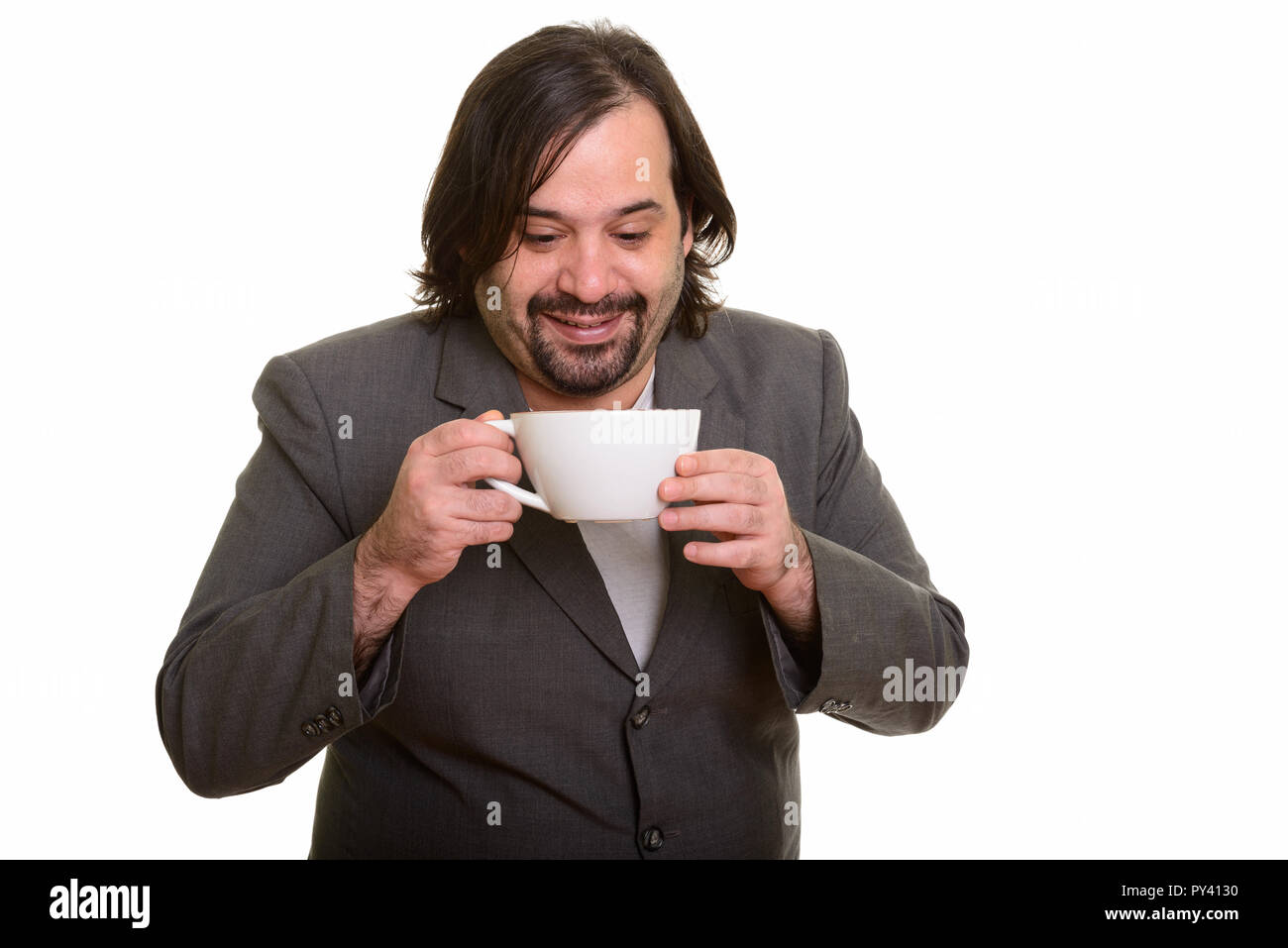 Felice grassi imprenditore caucasico sorridente e di bere il caffè Foto Stock