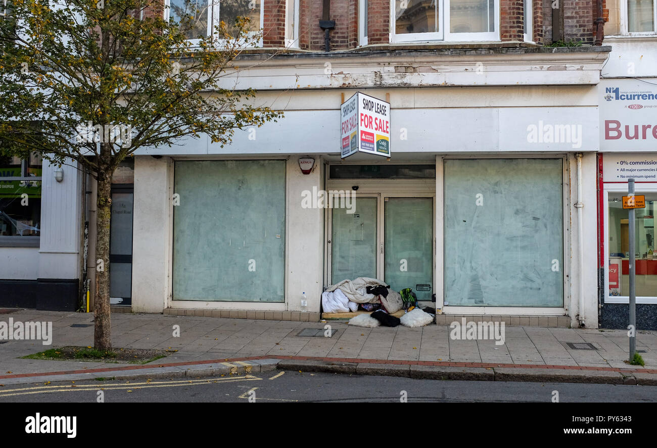 Worthing West Sussex viste & negozi al dettaglio - il sacco a pelo di senzatetto nella porta del negozio vuoto con contratto di locazione per la vendita Foto Stock