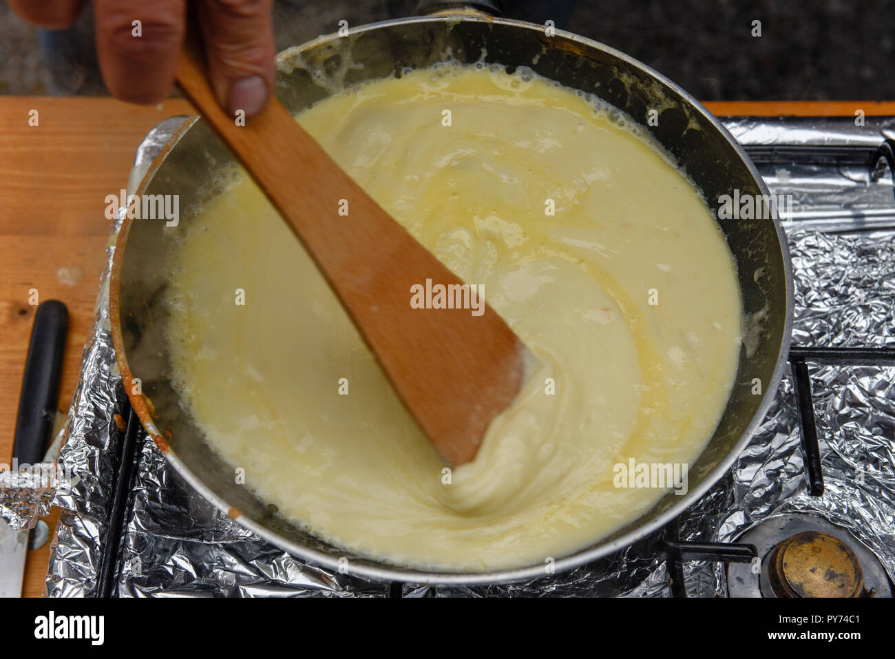 Preparazione del tradizionale formaggio fuso in una pentola sulla Svizzera Foto Stock