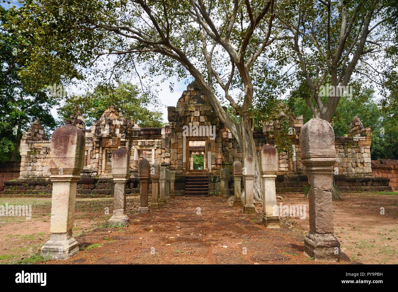Laterite tratto lastricato in pietra con pali in pietra alle porte del 11esimo secolo antico tempio Khmer Prasat Sdok Kok Thom in Sa Kaeo provincia della Thailandia Foto Stock