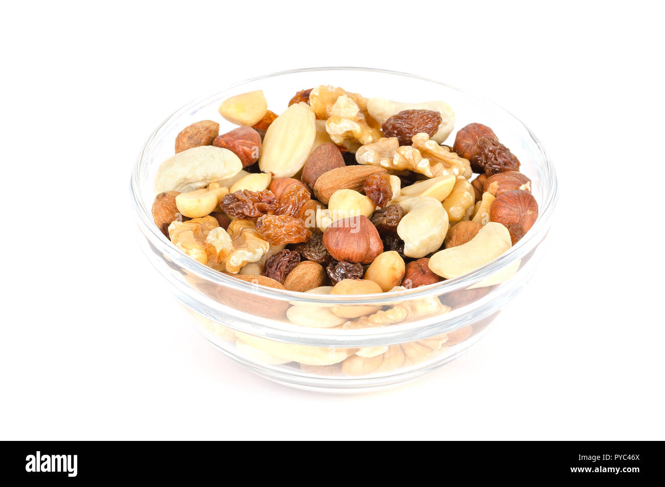 Studente di alimenti in recipiente di vetro. Studente di foraggio. Snack mix di mandorle essiccate, anacardi, arachidi, noci, nocciole e uvetta. Percorso misto. Foto Stock