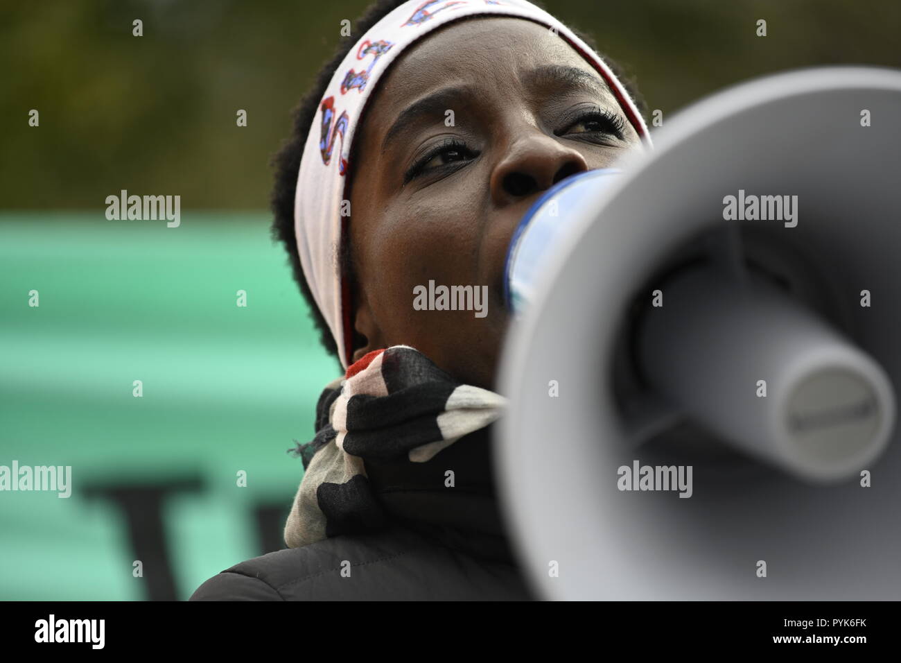 New York, Stati Uniti Il 28 ottobre 2018. Statua della Libertà scalatore Patricia Okoumou parla ai manifestanti che chiede di impeachment del presidente Donald Trump in un rally di New York Battery Park. Okoumou, un Congo native, facce prova nella corte federale a Manhattan sul Dic 17 sulle spese relative al suo atto di disobbedienza civile il 4 luglio quando ha scalato il piedistallo della Statua della Libertà per protestare contro la Trump administration le politiche di immigrazione. Credito: Joseph Reid/Alamy Live News Foto Stock