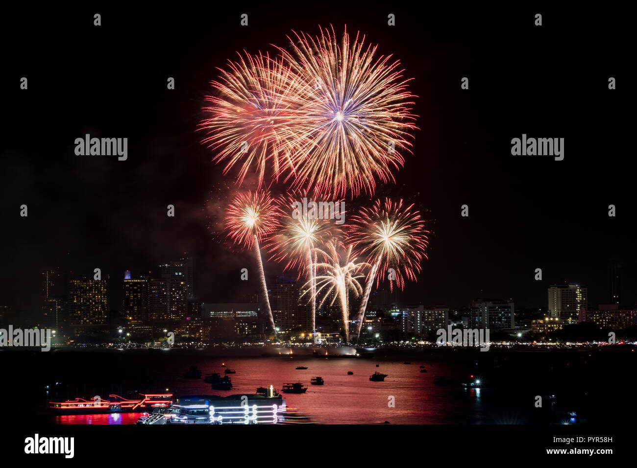Fuochi d'artificio esplorato oltre il paesaggio urbano di notte nel porto di mare a Pattaya.vacanza festosa celebrazione sfondo Foto Stock