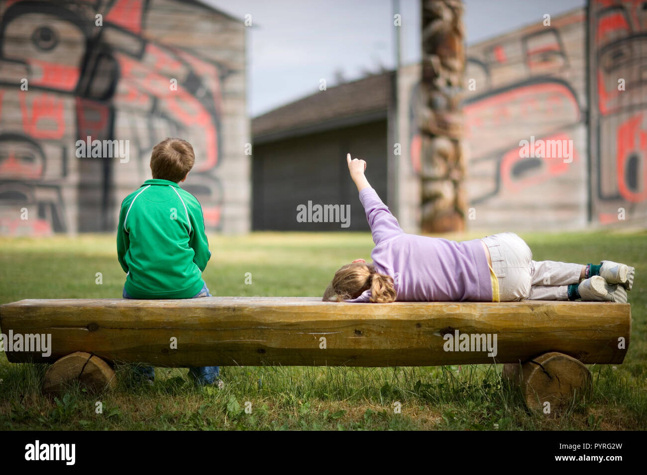 Due bambini seduti su una panca in legno. Foto Stock