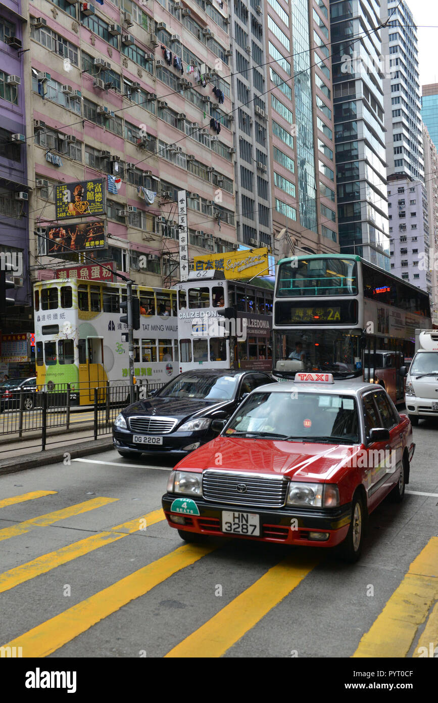 Cina: Hong Kong. Taxi rosso acceso sul GPL, double-decker bus e Mercedes Foto Stock