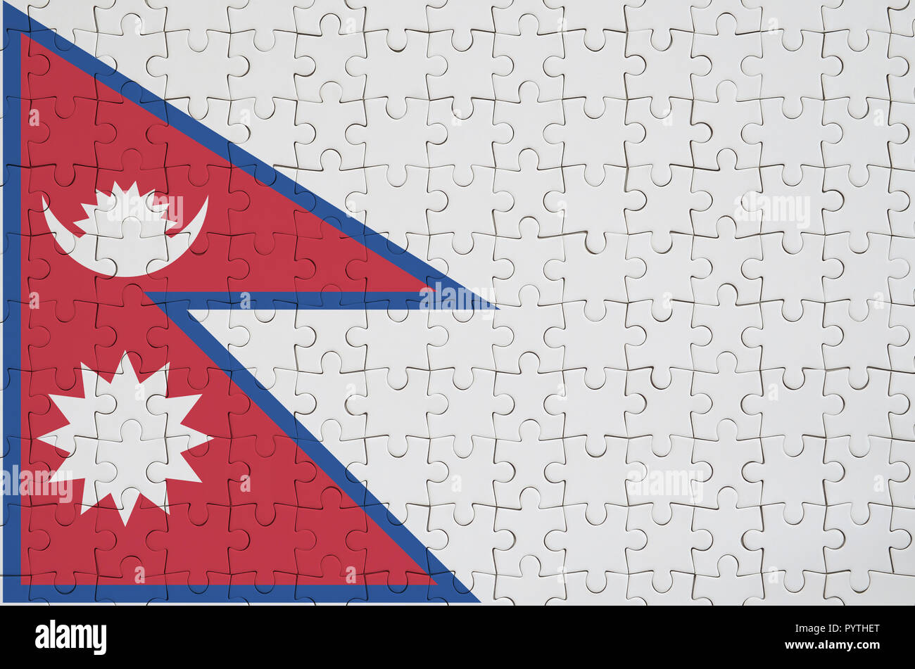 Il Nepal flag è raffigurato su un puzzle piegato Foto Stock