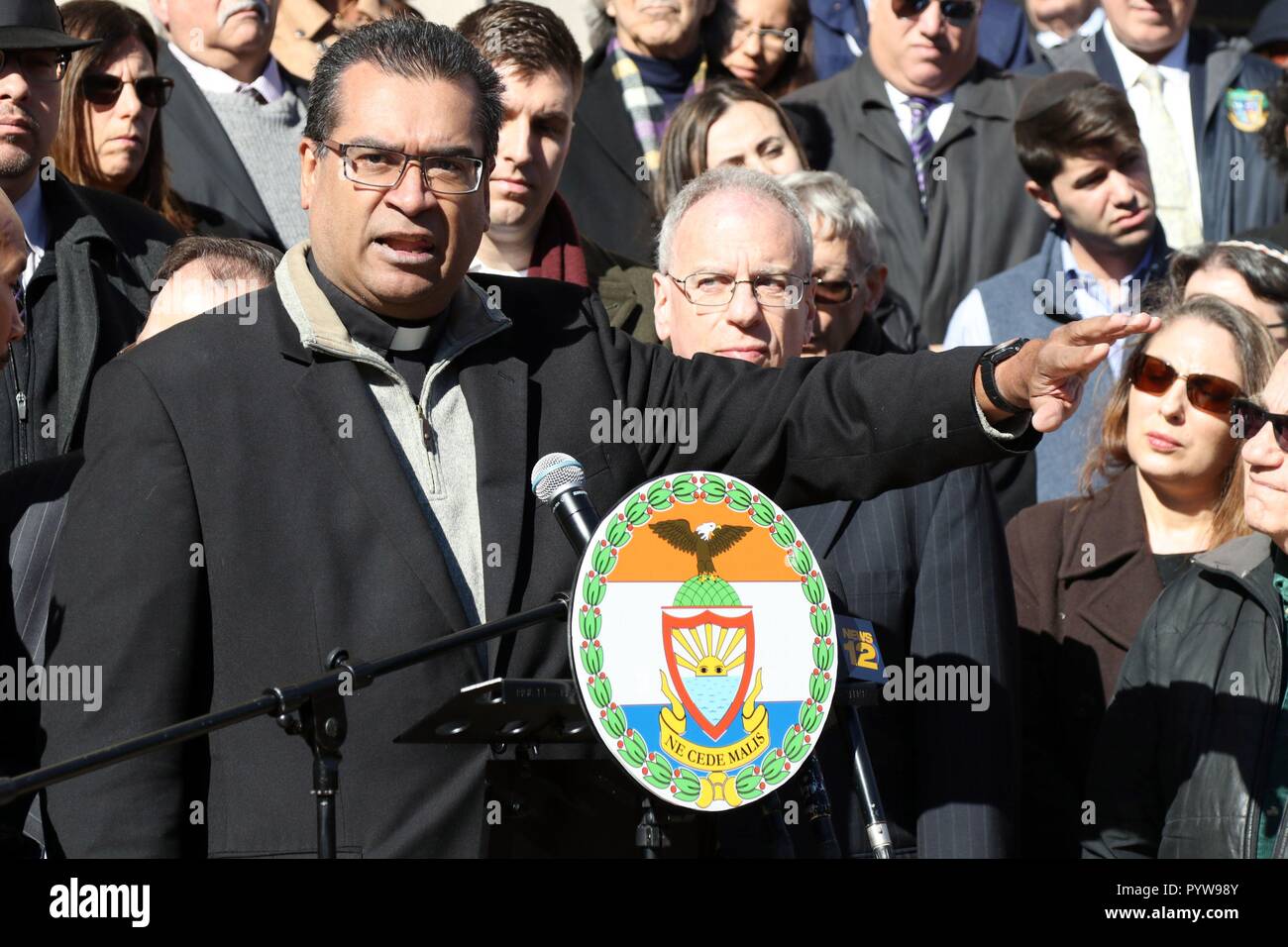 La città di New York, New York, Stati Uniti d'America. 30 ott 2018. Fr. Eric Cruz di Catholic Charities di NY, affrontare la folla a una preghiera interconfessionale veglia ospitato dal Bronx Borough President Ruben Diaz Jr e la comunità ebraica Consiglio Relazioni di New York, si è tenuto presso il Bronx County edificio su 30 Ottobre, 2018. Dirigenti eletti, clero, corte funzionari, organizzazioni comunitarie e altri si unirono nel supporto con la comunità ebraica e si fermò uniti contro l'odio alla veglia di mezzogiorno. Credito: G. Ronald Lopez/ZUMA filo/Alamy Live News Foto Stock