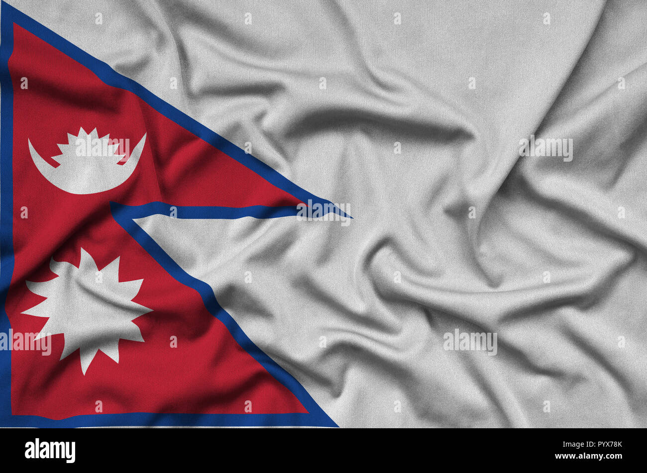 Il Nepal flag è raffigurato su un panno sport tessuto con molte pieghe. Sport team sventolando striscioni Foto Stock
