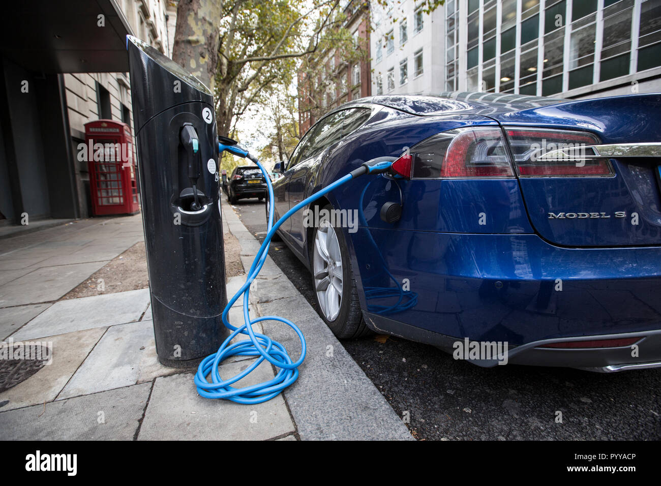 Tesla Model S auto elettrica la carica sulla street nel centro di Londra, Inghilterra, Regno Unito Foto Stock