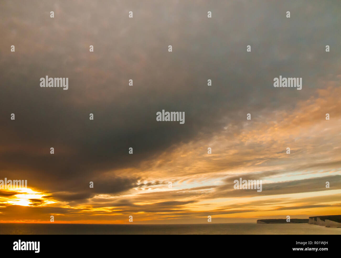 Birling Gap, Eastbourne, East Sussex, Regno Unito..31 ottobre 2018. Le nuvole Interessanti al tramonto creano colori gloriosi nel cielo. Sette Sorelle falesie gesso A Destra di foto. Una tad calda stasera con vento dal Sud Est .. Foto Stock