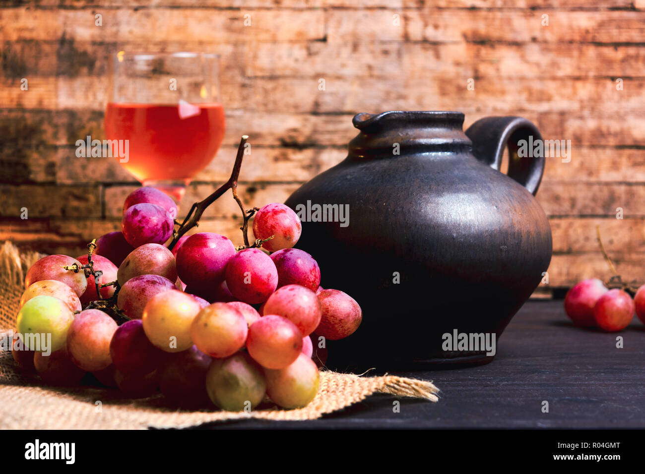Mosti di uve fresche e vini fatti in casa su un tavolo rustico Foto Stock