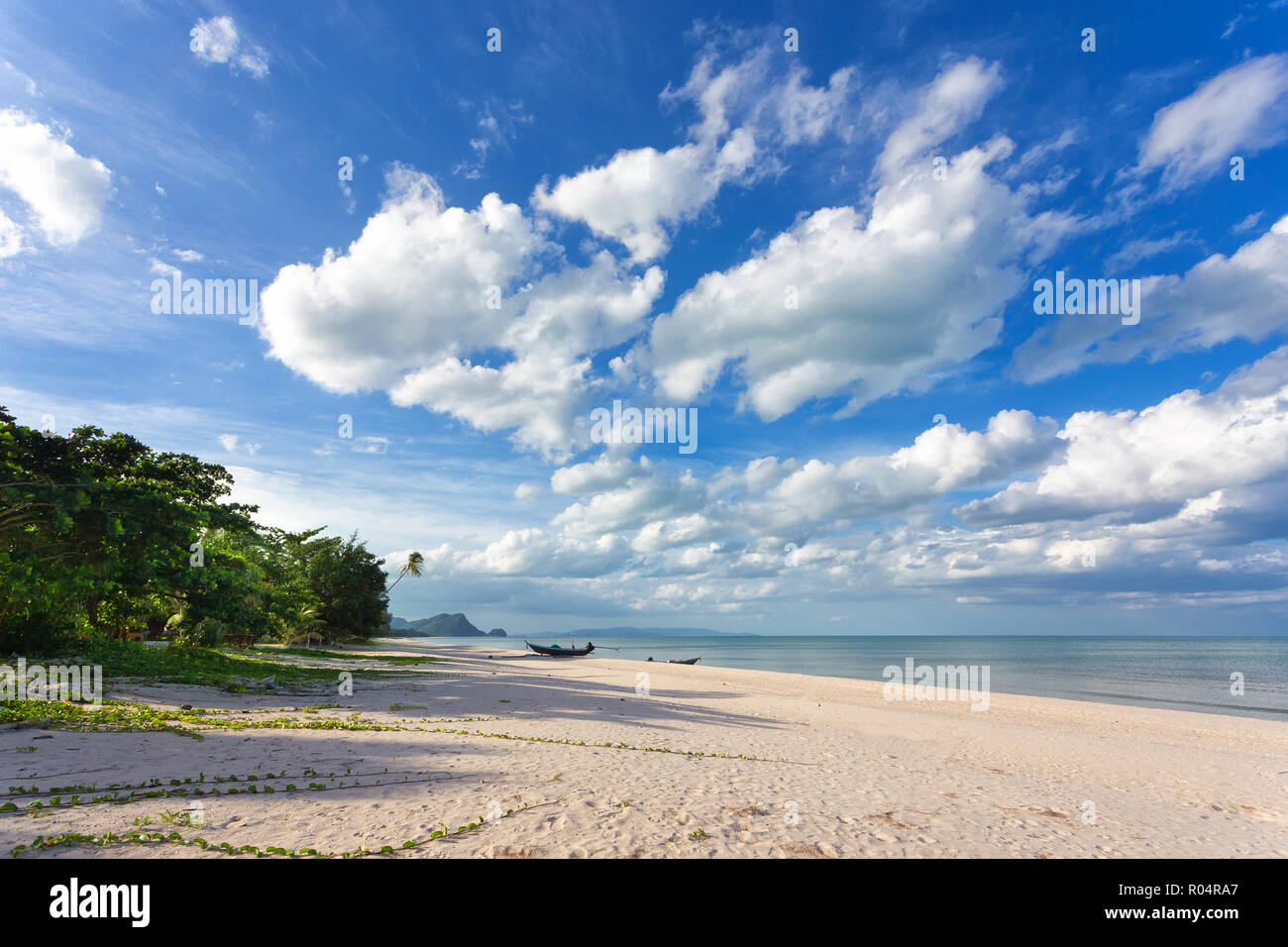 Wild Khanom tropicale spiaggia sotto un blu e il cielo nuvoloso, Thailandia Foto Stock