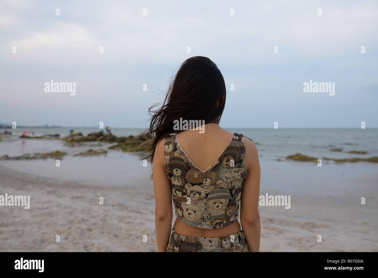 Vista posteriore della giovane donna asiatica guardando alla vista panoramica del pub Foto Stock