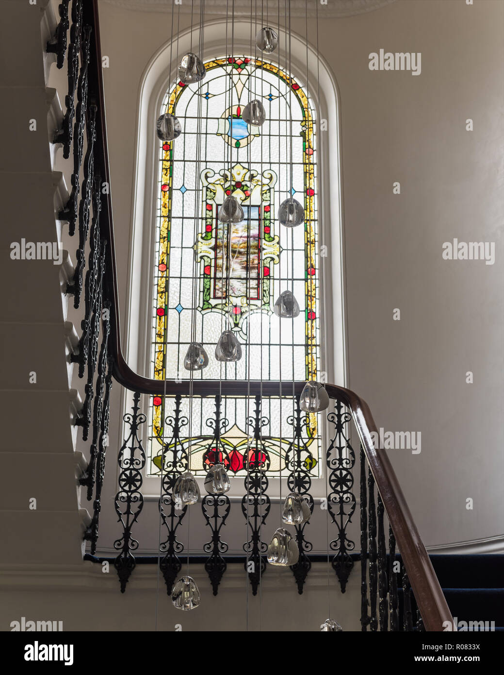 Vetrata sulla scalinata dalla luce pendente Foto Stock