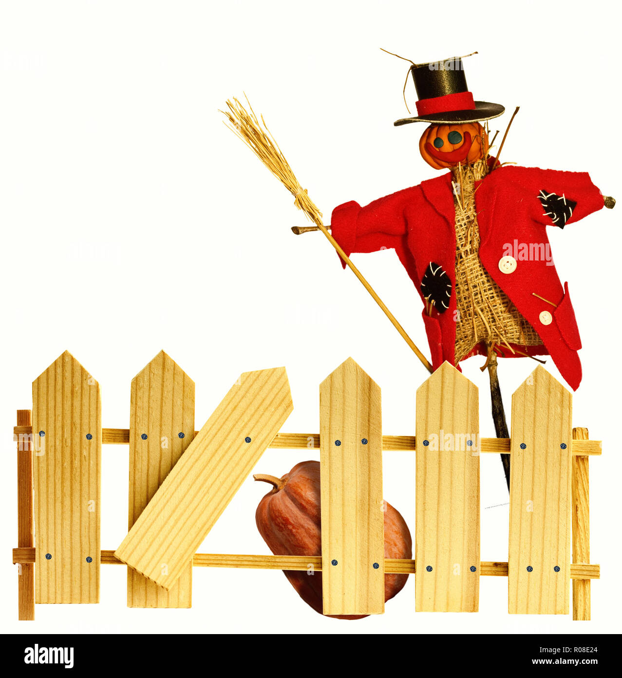 Giocattolo divertenti spaventapasseri in piedi dietro una recinzione di legno Foto Stock