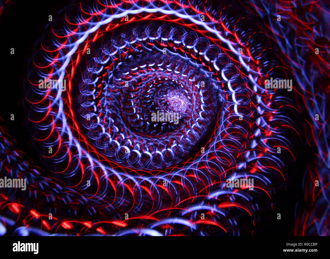Abstract sullo sfondo di una configurazione formata dalla luce della pittura con un sollievo comico palla leggera spinner Foto Stock