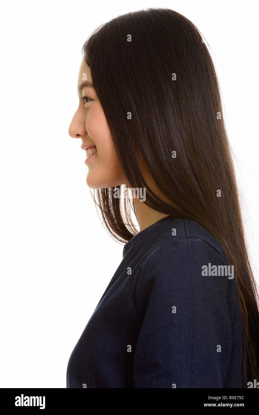 Vista di profilo di giovani asiatici felice ragazza sorridente Foto Stock