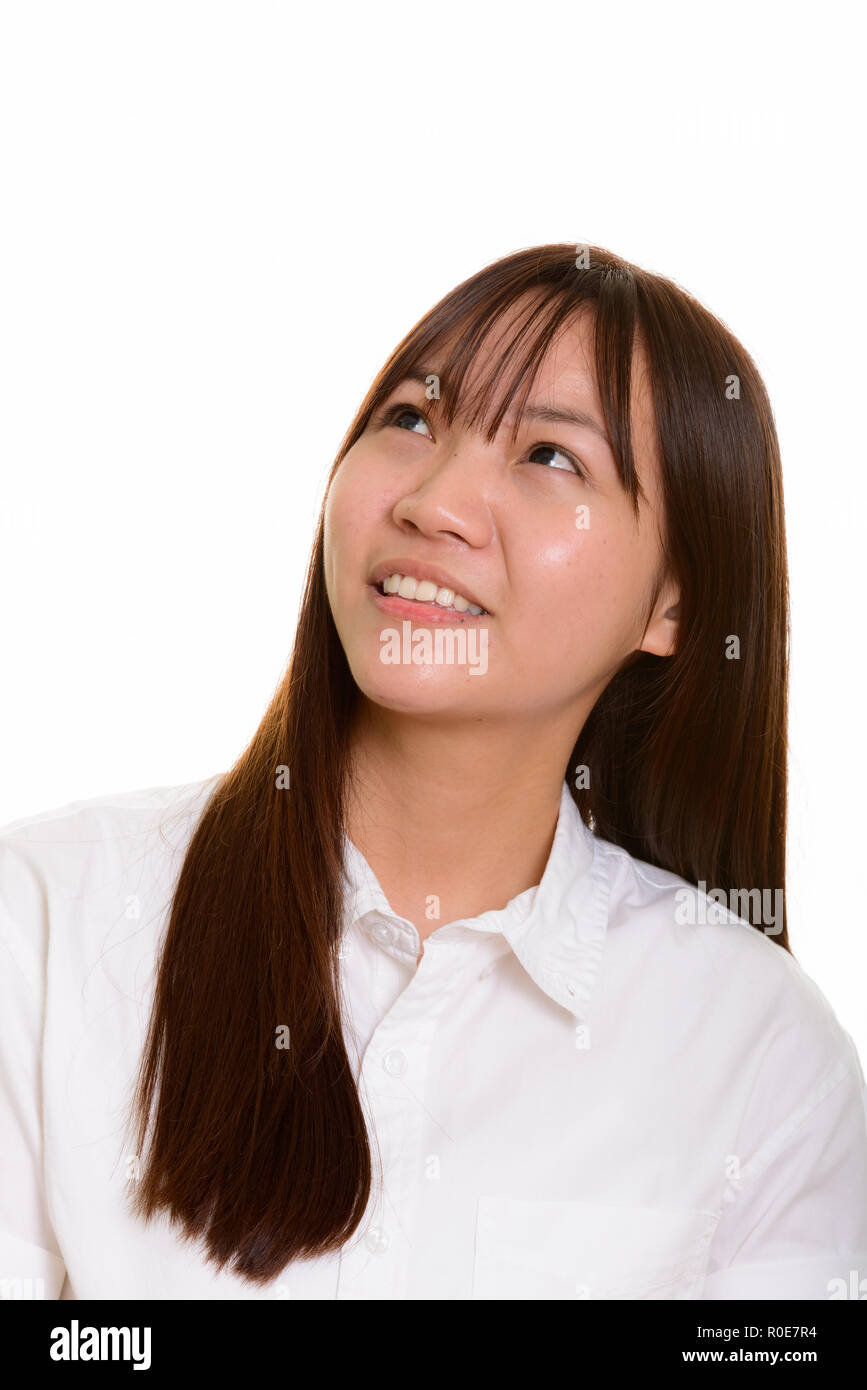 Giovani asiatici felice ragazza sorridente e pensare Foto Stock