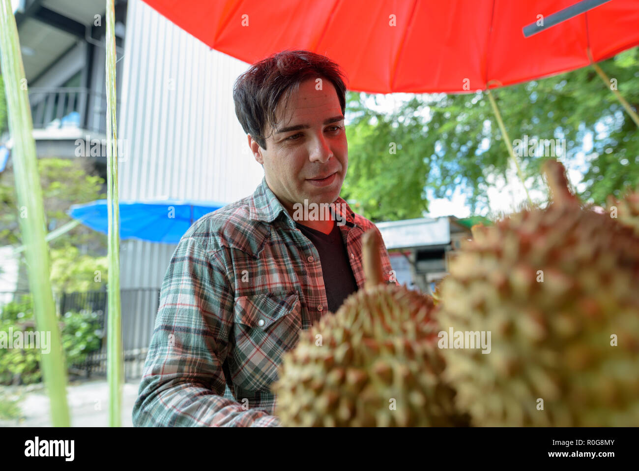 Bel uomo turistico acquistare frutta Durian in street shop Foto Stock