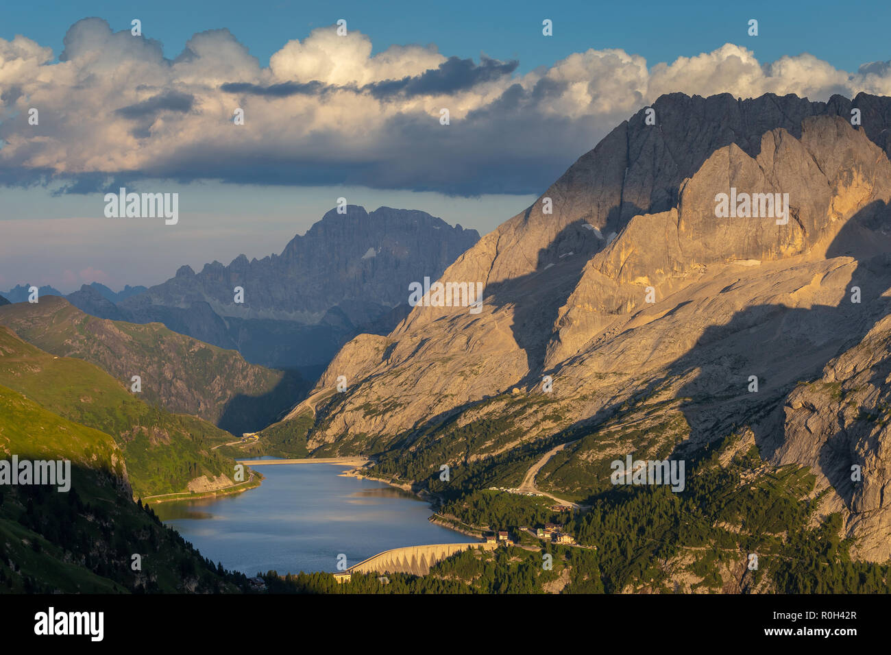 Tramonto luce solare sul Lago Fedaia e il gruppo montuoso della Marmolada. Sullo sfondo Monte Civetta. Le Dolomiti. Alpi Italiane. Europa. Foto Stock