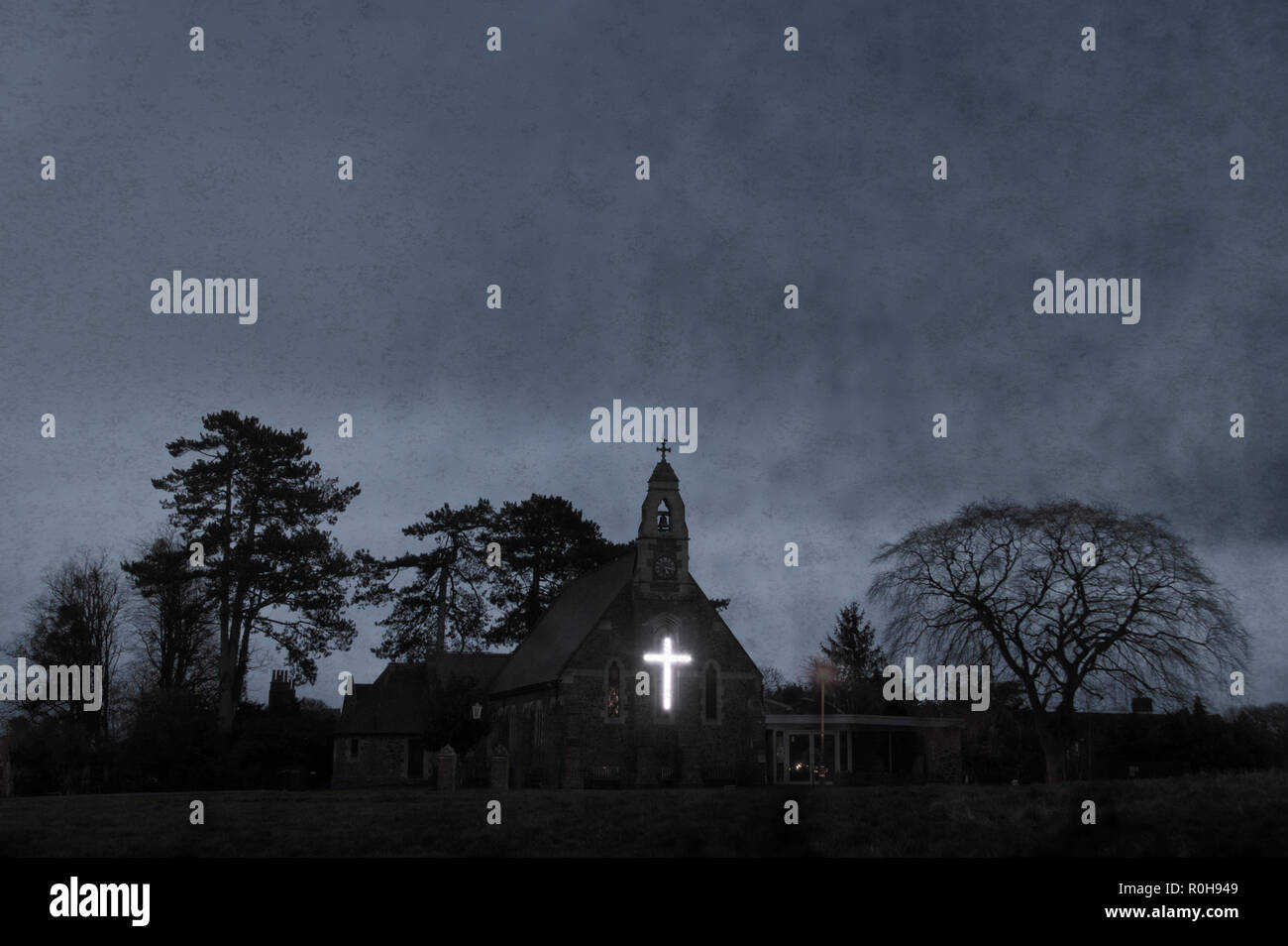 Una chiesa stagliano su un inverni di sera con una luce bianca croce dell'edificio. Utilizzando un grunge, vintage modifica. Foto Stock