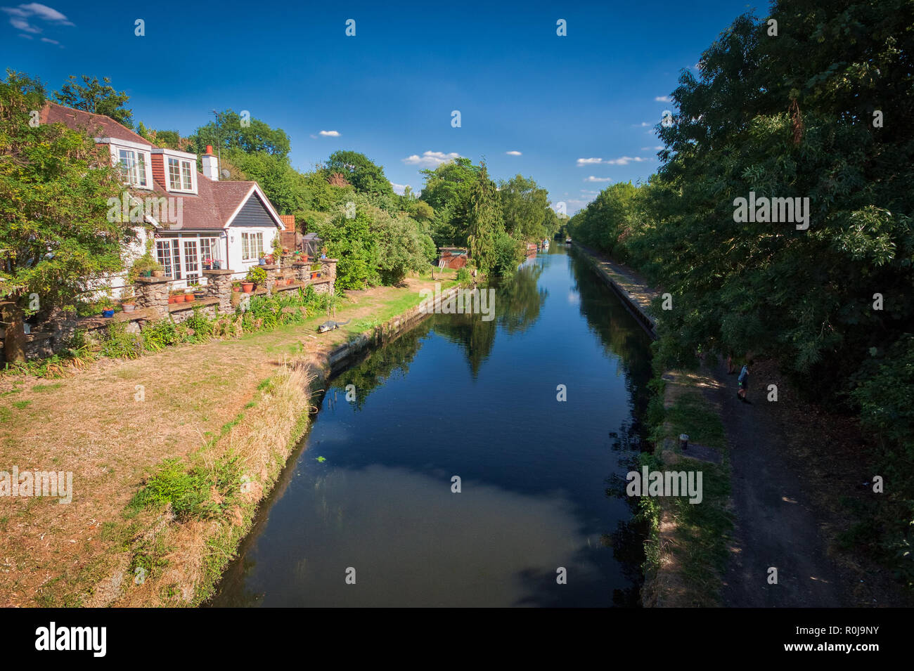 Una casa in una giornata estiva soleggiata vista dal Black Jack's Lock a Harefield sul Canal Grand Union, Regno Unito Foto Stock