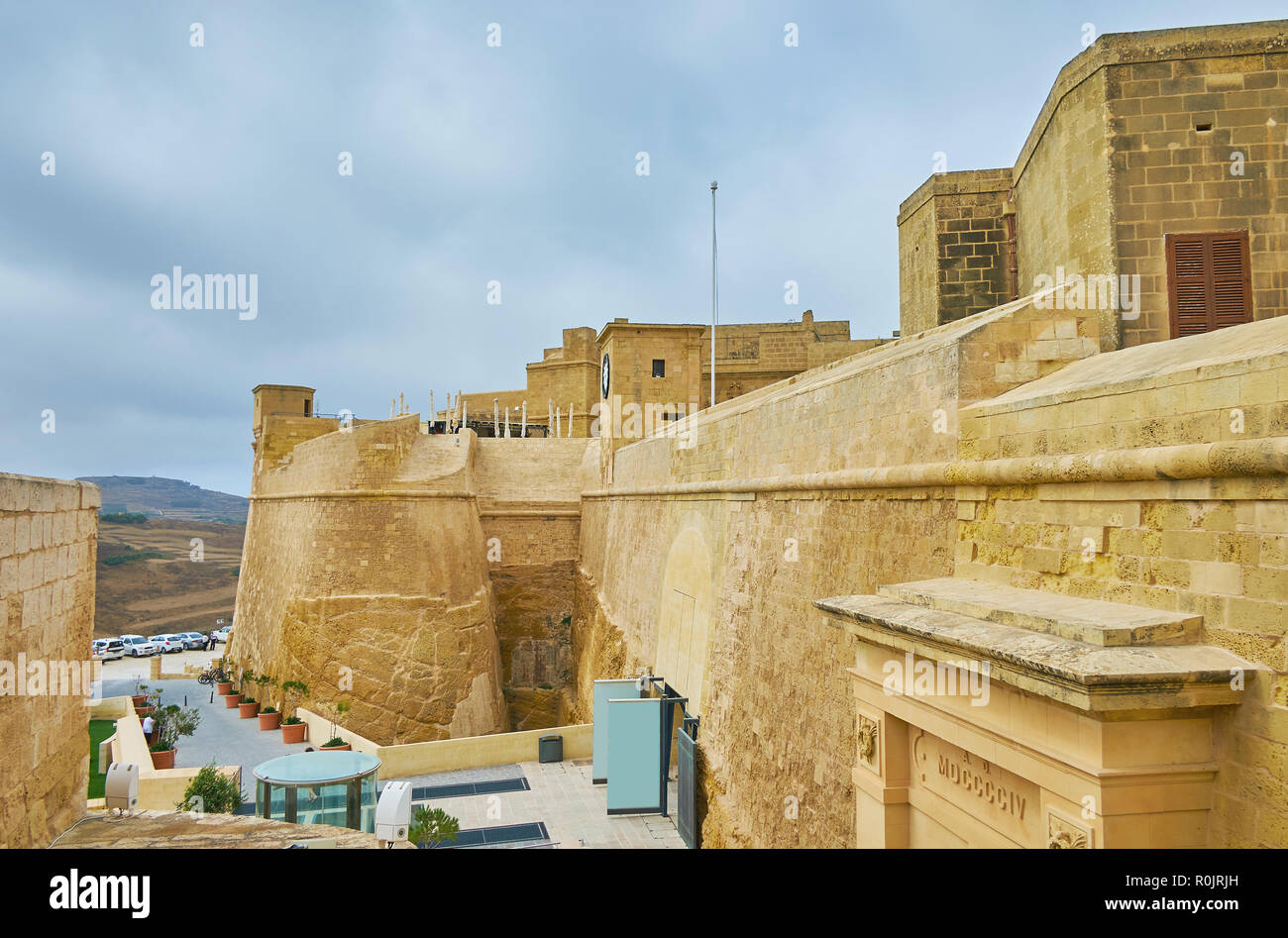 La grande pietra mura e i bastioni della cittadella di Rabat con una vista sul suo cancello principale e St Martin Demi Bastion, Victoria, isola di Gozo, Malta. Foto Stock