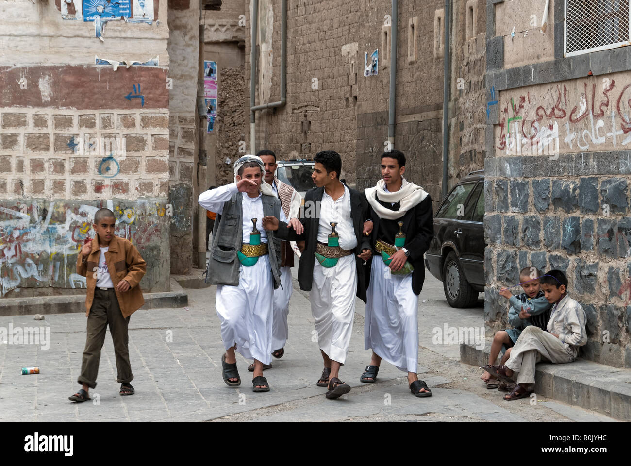 Un gruppo di giovani uomini a piedi in una strada, indossando i loro coltelli tradizionali janbiyas maggio su 4, 2007 in Sanaa, Yemen Foto Stock