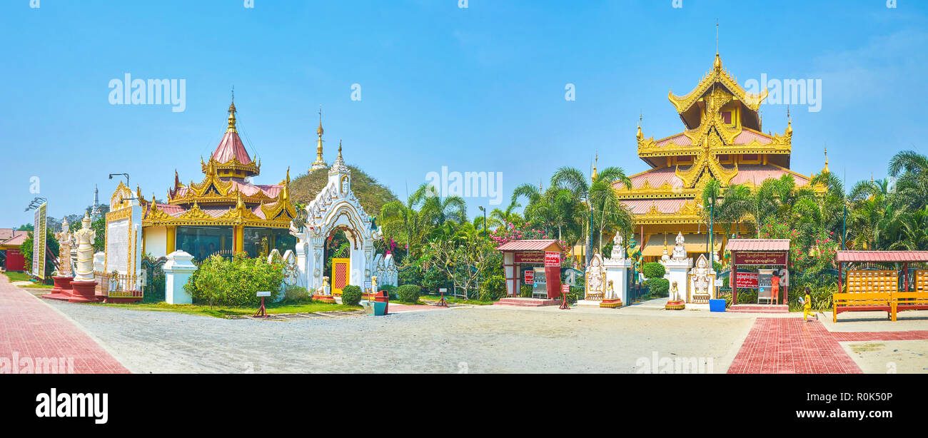 MANDALAY, MYANMAR - Febbraio 23, 2018: vista panoramica sul cortile della Pagoda Kyauktawgyi complesso con la guglia del santuario dietro gli alberi, su Foto Stock