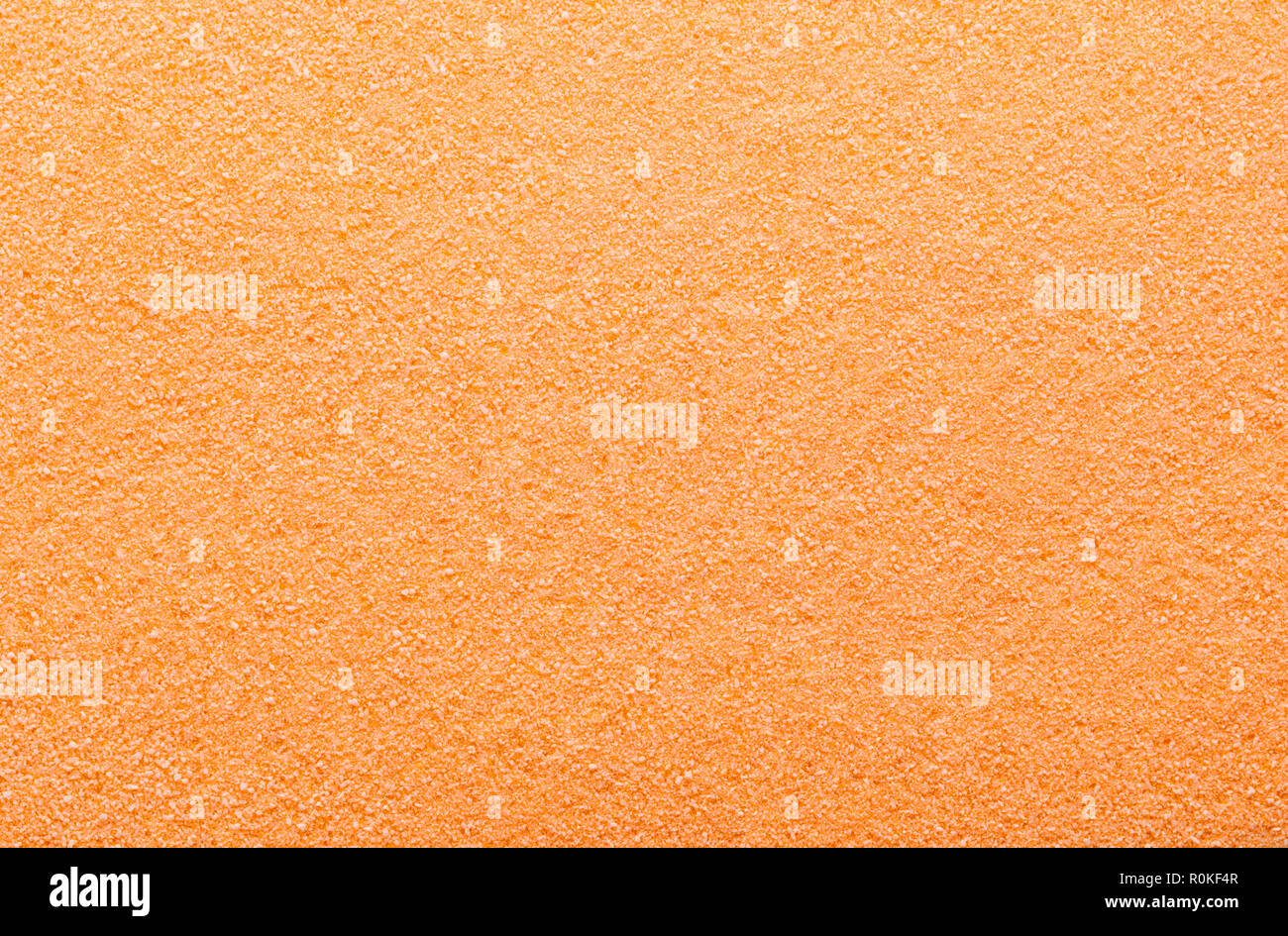 Appartamento pila di arancio granella di zucchero Textured Background. Foto Stock