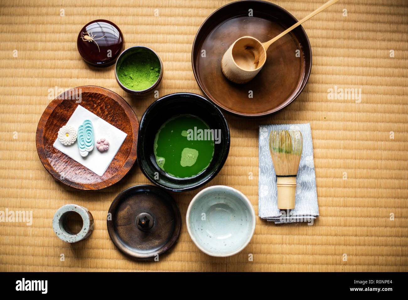 La cerimonia del tè utensili compresi ciotola di verde Matcha tè, una frusta di bambù e Wagashi dolci. Foto Stock