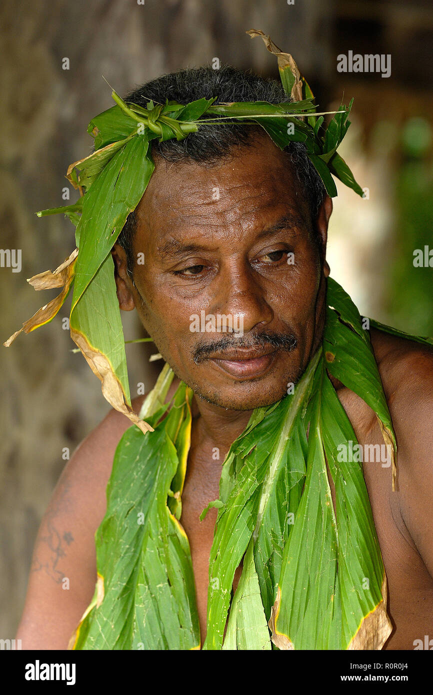 Einheimischer Mann mit Palmblättern geschmückt, Porträt, Yap, Mikronesien | uomo locale indossando le foglie di palma, sudorazione, ritratto, Yap, Stati Federati di Micronesia Foto Stock