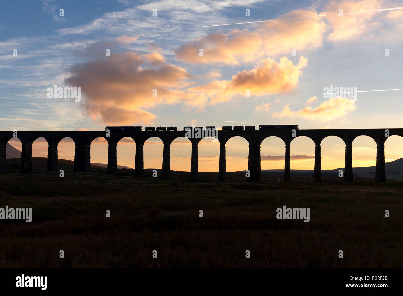 2 Direct rail services class 66 locomotive passando il viadotto Ribblehead con un binario di testa treno di trattamento trattamento con foglie di autunno sulla linea. Foto Stock