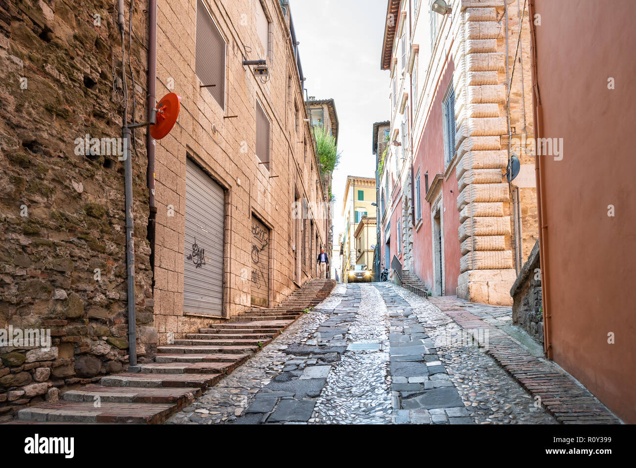 Perugia, Italia - 29 agosto 2018: Via Bartolo stretta, la vecchia strada di ciottoli, su strada con vetture, gente camminare nell antica, storica città medievale, città Foto Stock