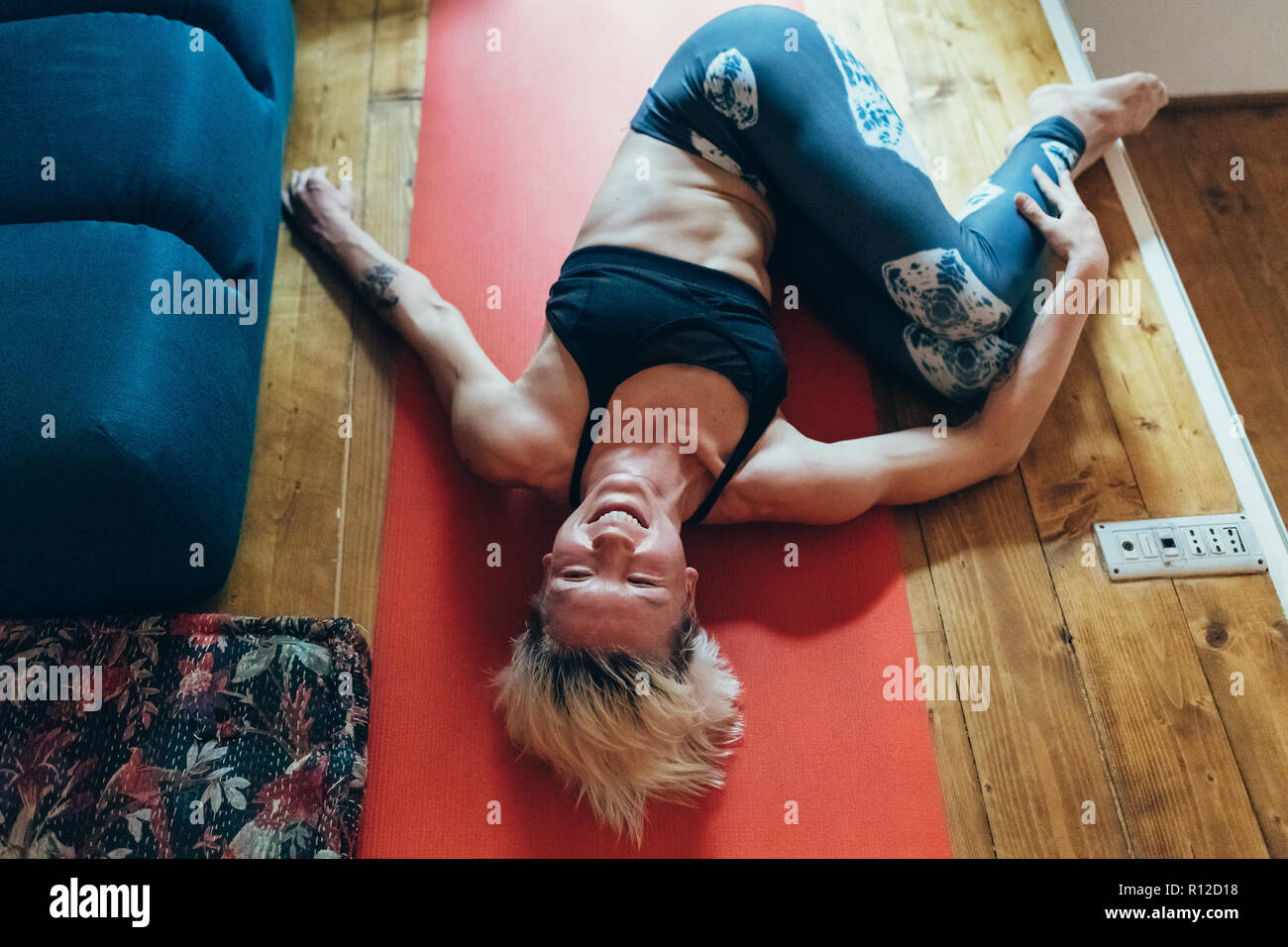 La donna a praticare yoga a casa Foto Stock