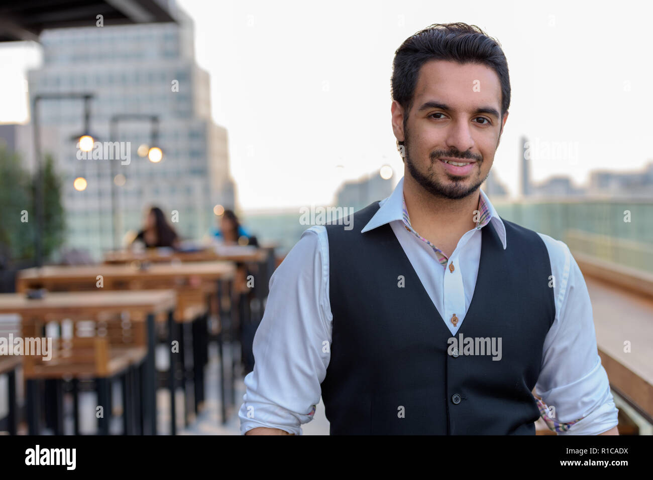 Giovani indiani felici uomo sorridente al ristorante sul tetto a Bangkok Foto Stock