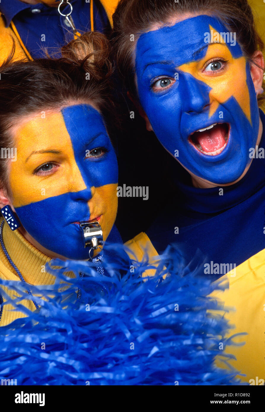 Entusiasti appassionati di sport con facce dipinte in un gioco, USA Foto Stock