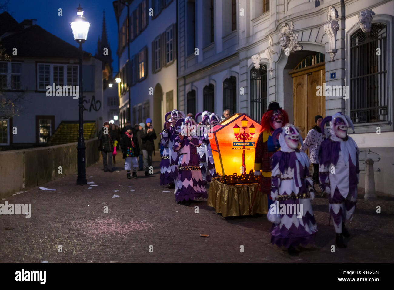 Il Carnevale di Basilea 2018. Rheinsprung Basel, Svizzera - Febbraio 19th, 2018. Un piccolo gruppo di carnevale con la loro lanterna accesa nella città vecchia Foto Stock