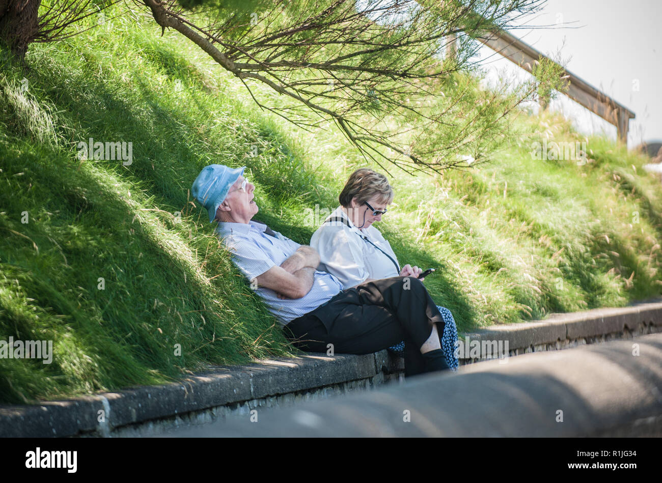 Regno Unito Meteo: Aberystwyth, Ceredigion, West Wales lunedì 18 luglio 2016. I vacanzieri e i locali approfittano dei primi del sole di mattina a piedi Foto Stock