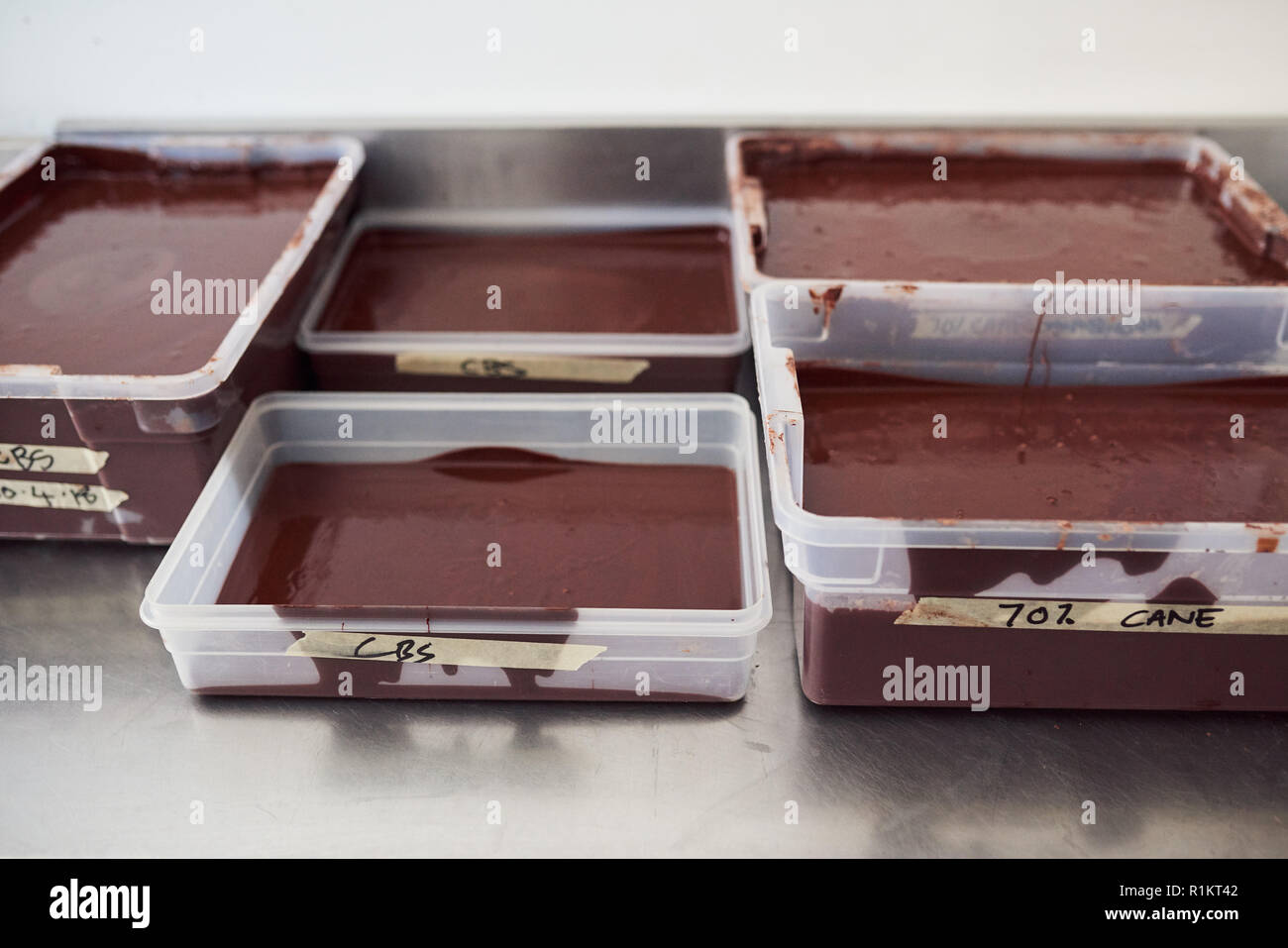 Raffreddamento di cioccolato in vassoi su una confetteria rendendo tabella di fabbrica Foto Stock