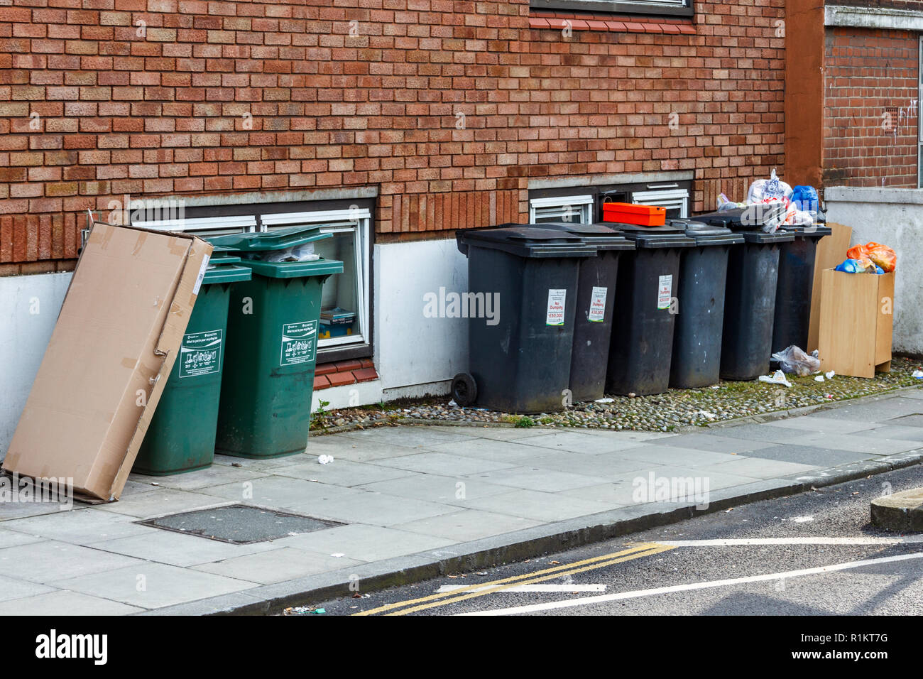 Il riciclaggio domestico cassonetti fuori proprietà residenziali in Hornsey Lane, Islington, London, Regno Unito Foto Stock