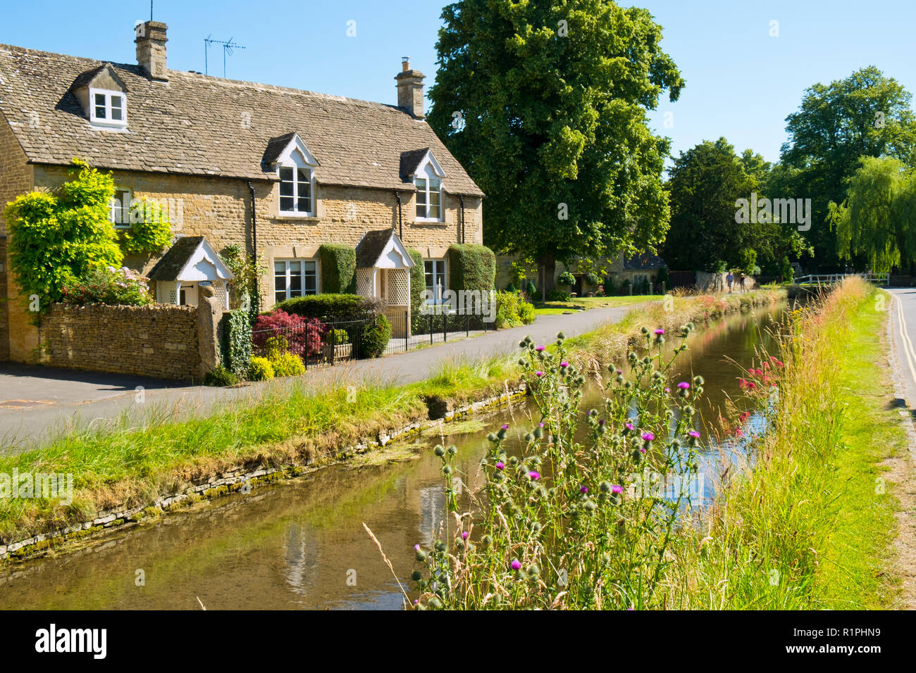 Lower Slaughter, Gloucestershire, Regno Unito - 19 Luglio 2016: sole estivo porta i visitatori al pittoresco villaggio Costwold di Lower Slaughter, Gloucestershire, UK. Il villaggio si trova a cavallo del fiume piccolo occhio e diversi piccoli ponti pedonali e una Ford unire i due lati della comunità. Foto Stock