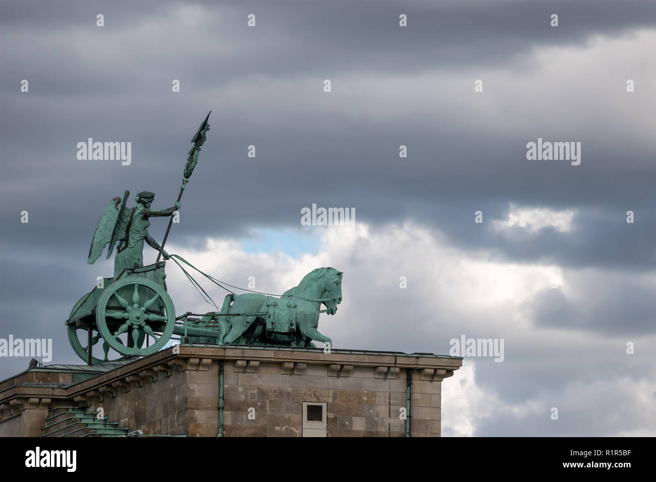 La Quadriga della Porta di Brandeburgo contro un cielo nuvoloso a Berlino, Germania Foto Stock