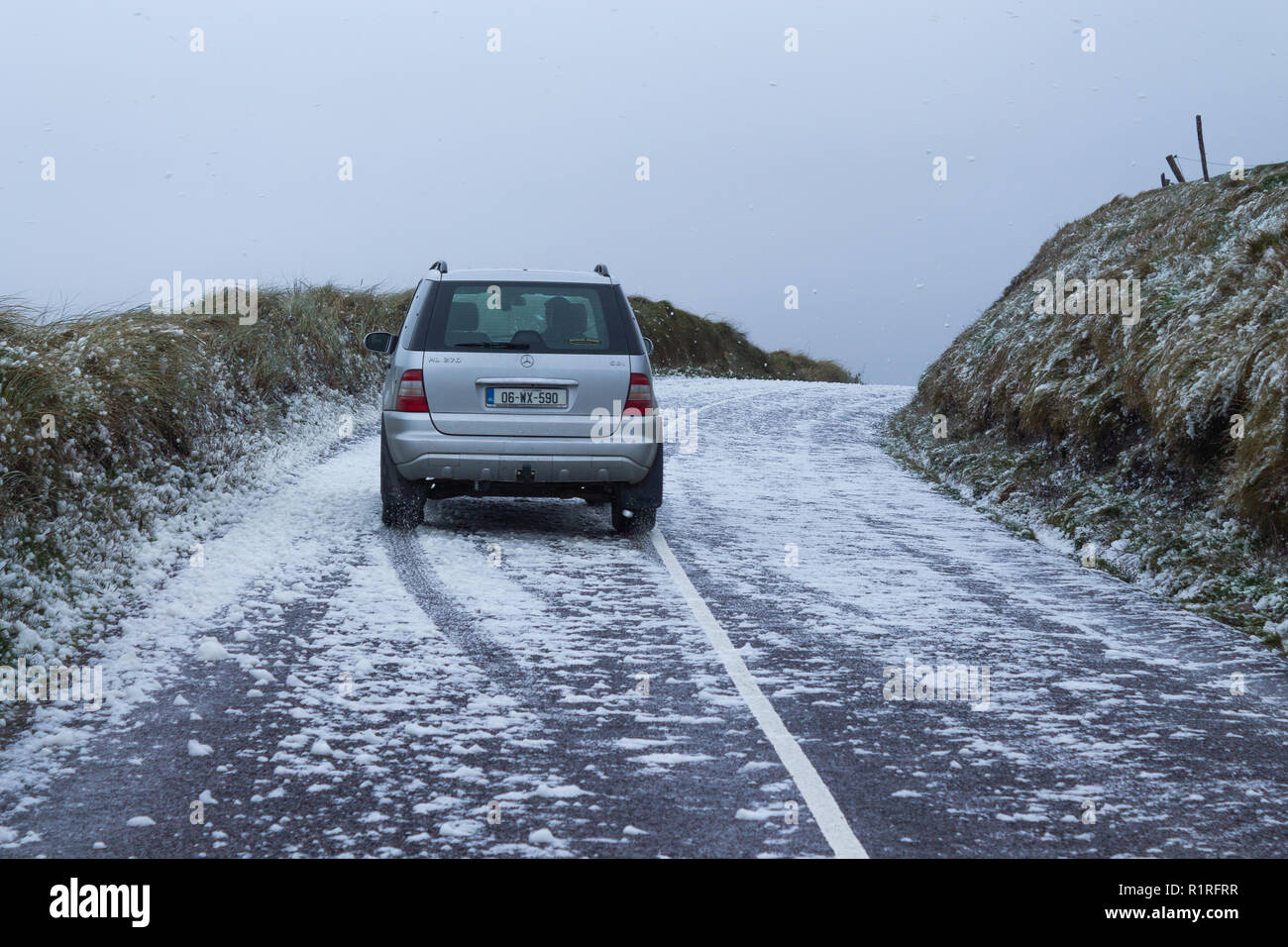 Rosscarbery, West Cork, Irlanda, 14 novembre 2018. Tempesta Onshore venti della forza ha portato un look invernale per le strade lungo le scogliere a vicino Owenahincha Rosscarbery, schiuma di mare agitato dai venti vetture ha dato una bufera di neve di bianco "neve" bolle a guidare attraverso. Credito: aphperspective/Alamy Live News Foto Stock