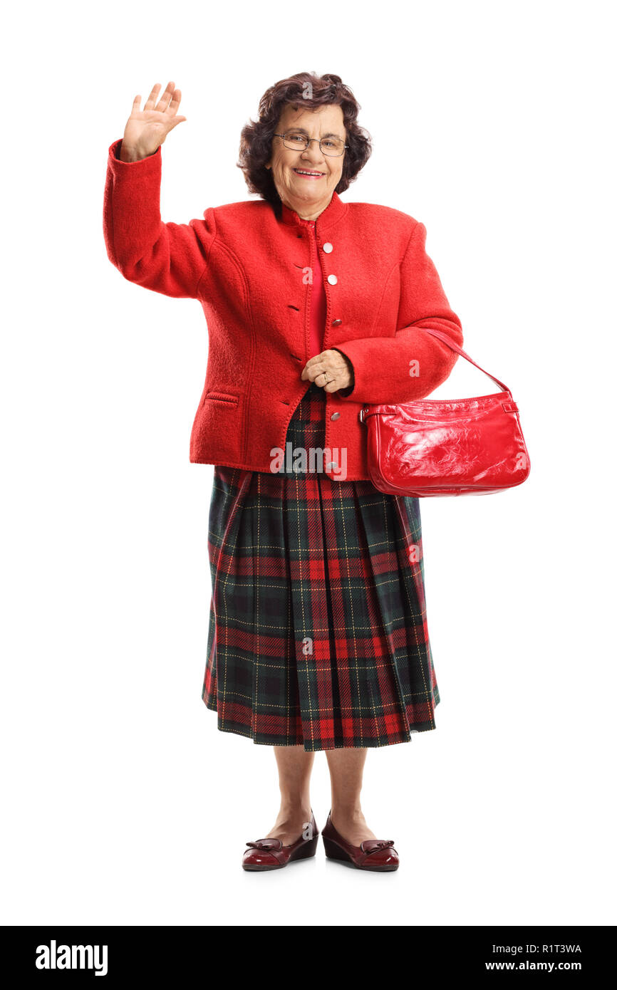 A piena lunghezza Ritratto di una dama senior sventolando la fotocamera a isolati su sfondo bianco Foto Stock