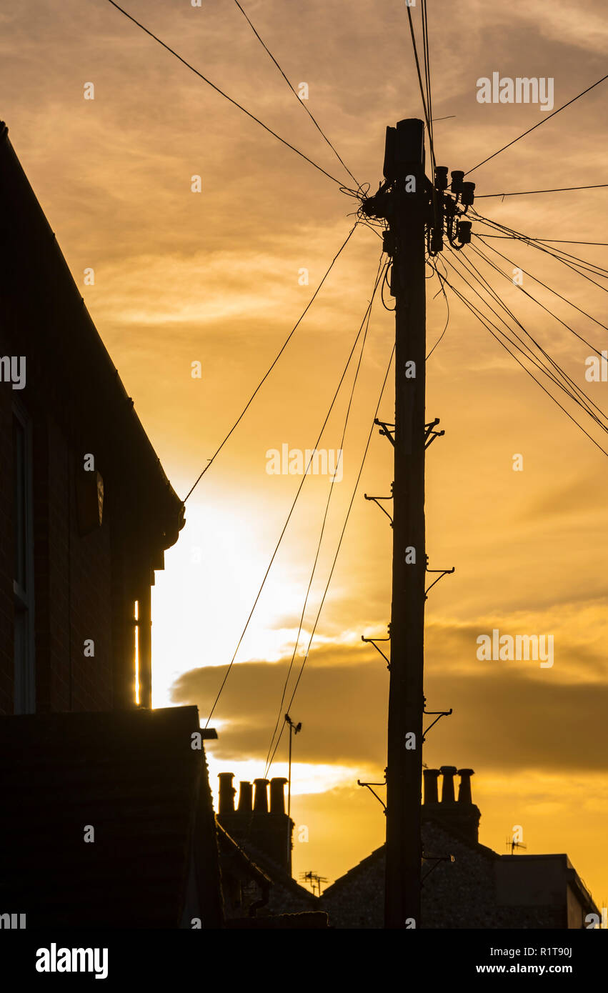 British BT telegrafo polo da case in una piccola città in Inghilterra, Regno Unito. Foto Stock