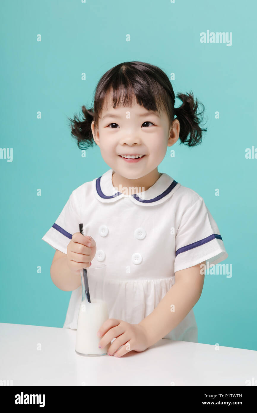 Poco bella ragazza asiatica di ridere ritratto con latte e pane, lifestyle sano e felice. Foto Stock